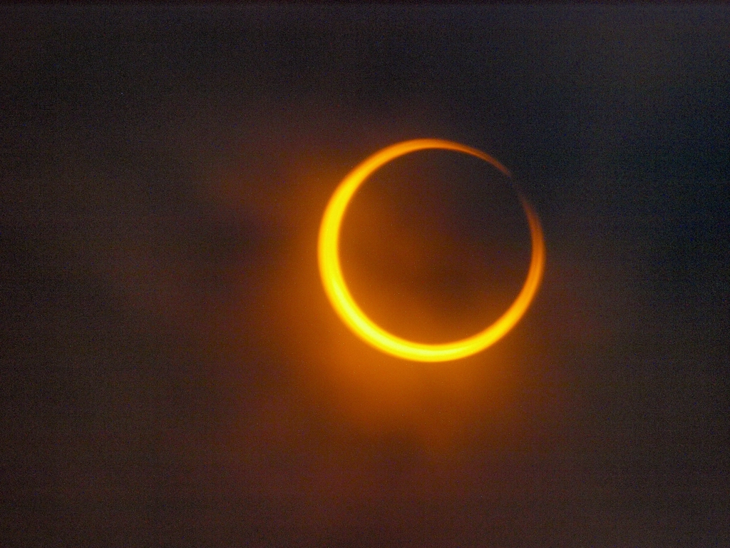 A total solar eclipse glowing against a dark sky, symbolizing new beginnings