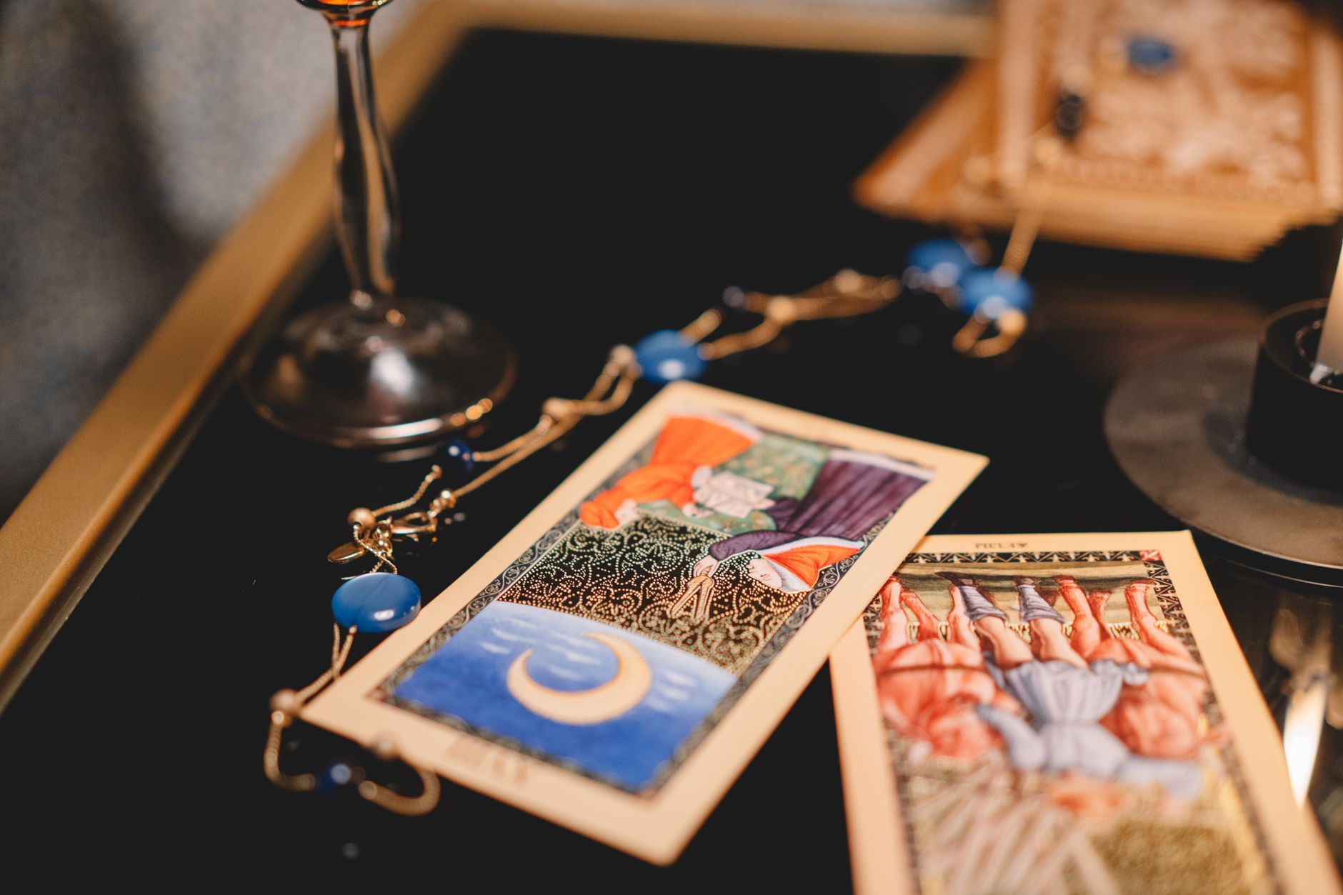 Tarot cards spread on a wooden table with autumn leaves, for a Libra season reading