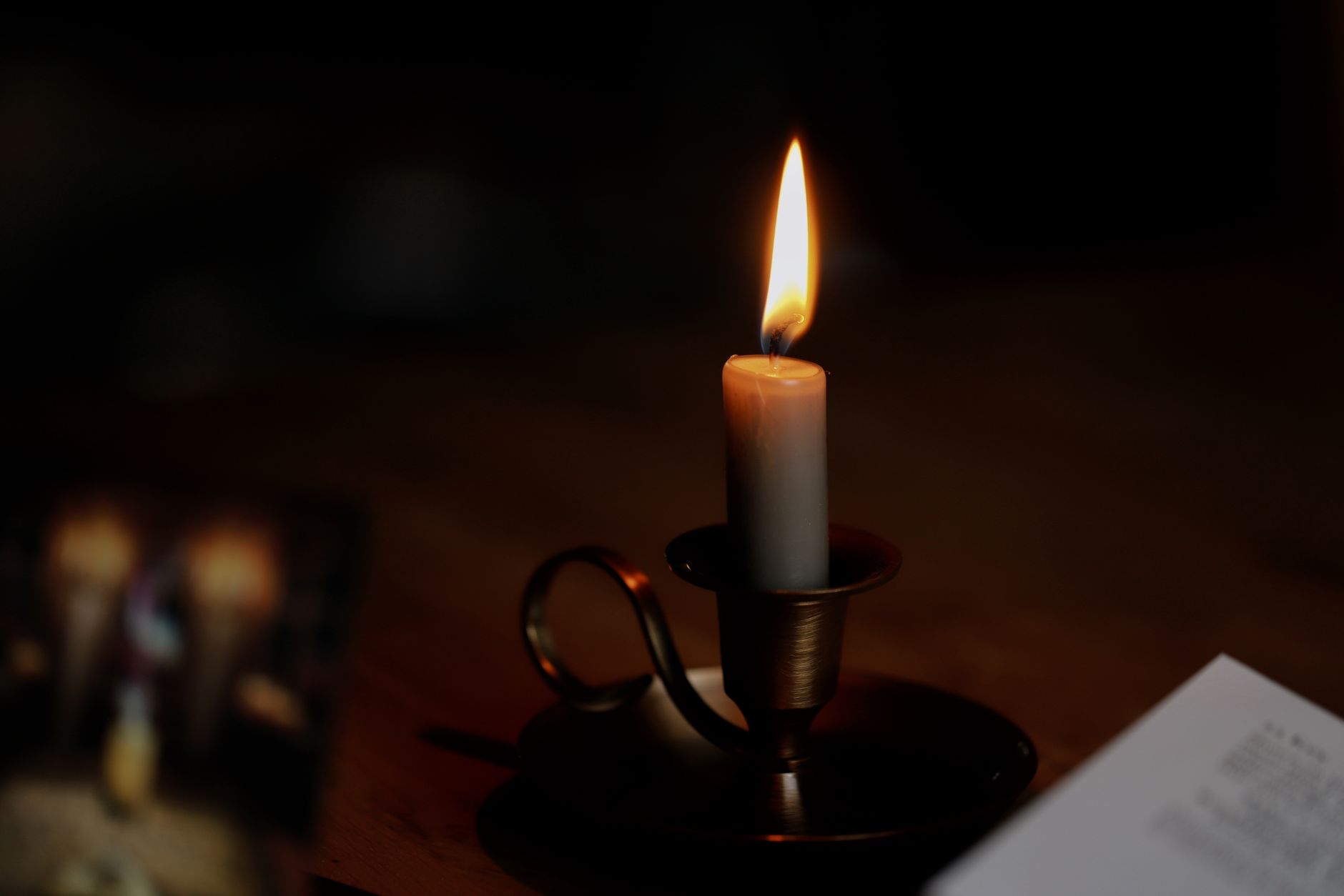 Tarot cards laid out on a table during a candlelit reading