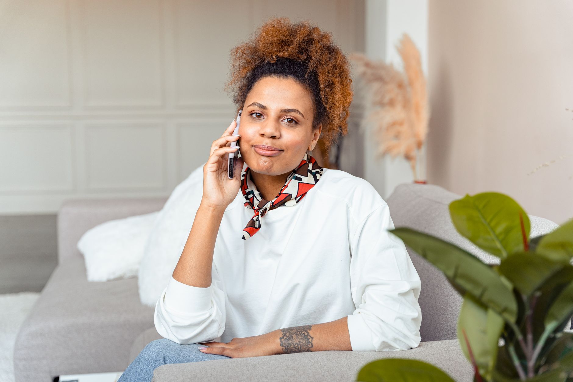 Woman relaxing at home on a phone call, representing a psychic reading by phone for a Port St. Lucie client
