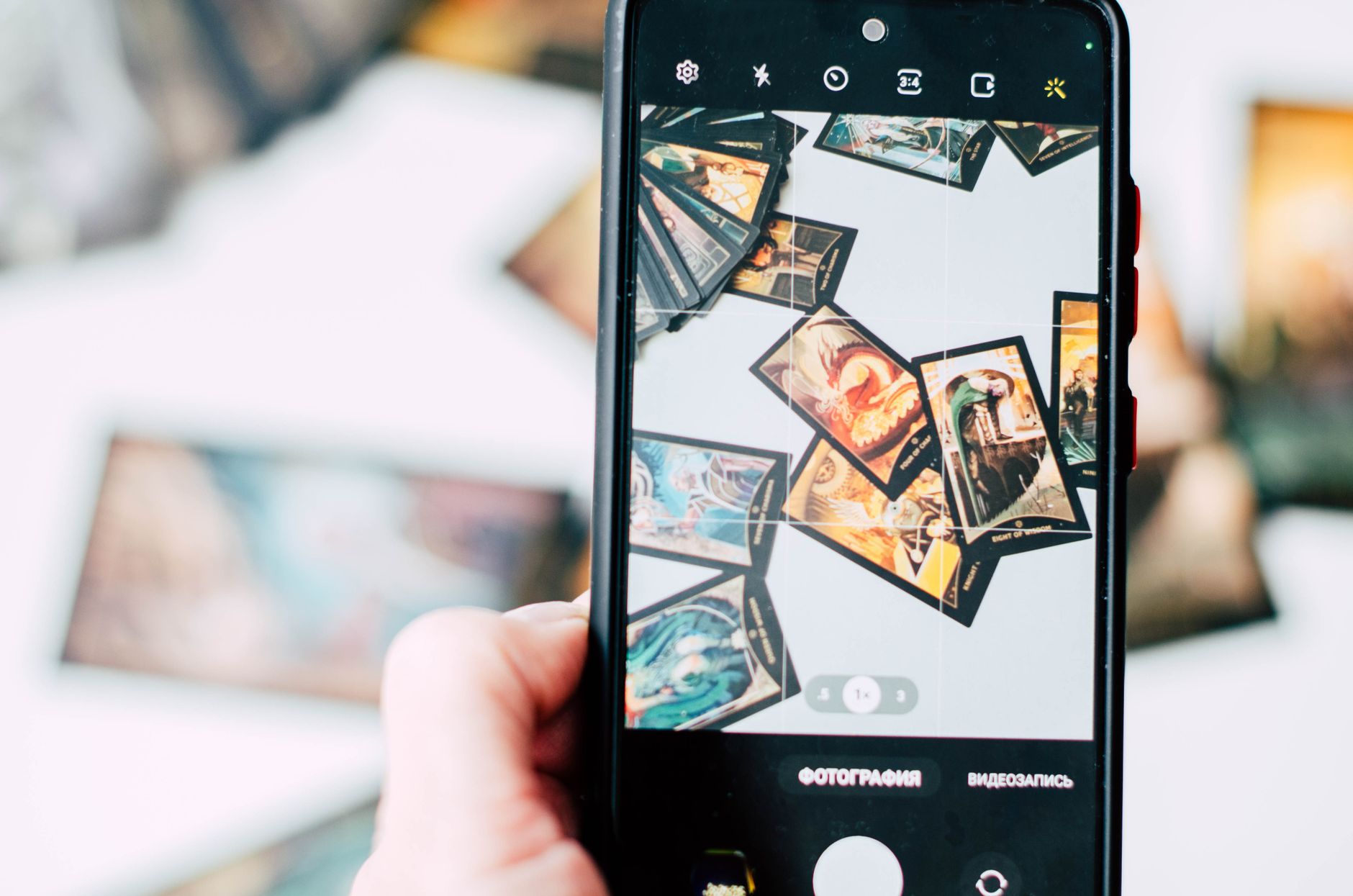 Tarot cards laid out on a table beside a phone during a reading